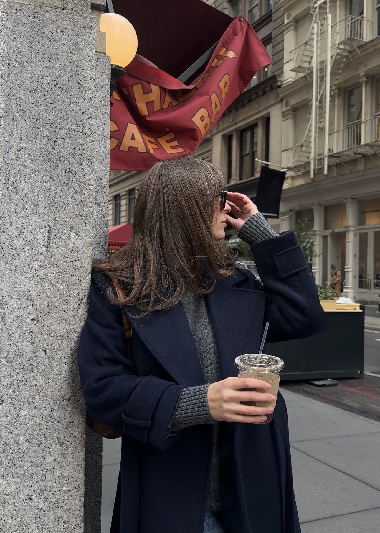 Kathryn Zahorak looking away and wearing black coat, navy sweater