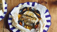 Hake and mussels in a bag with beer, bacon and leeks