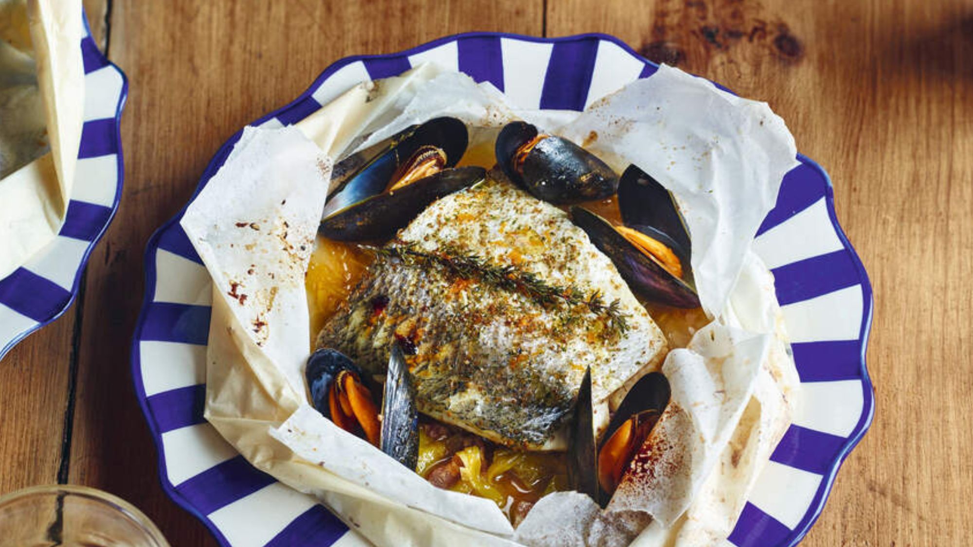 Hake and mussels in a bag with beer, bacon and leeks