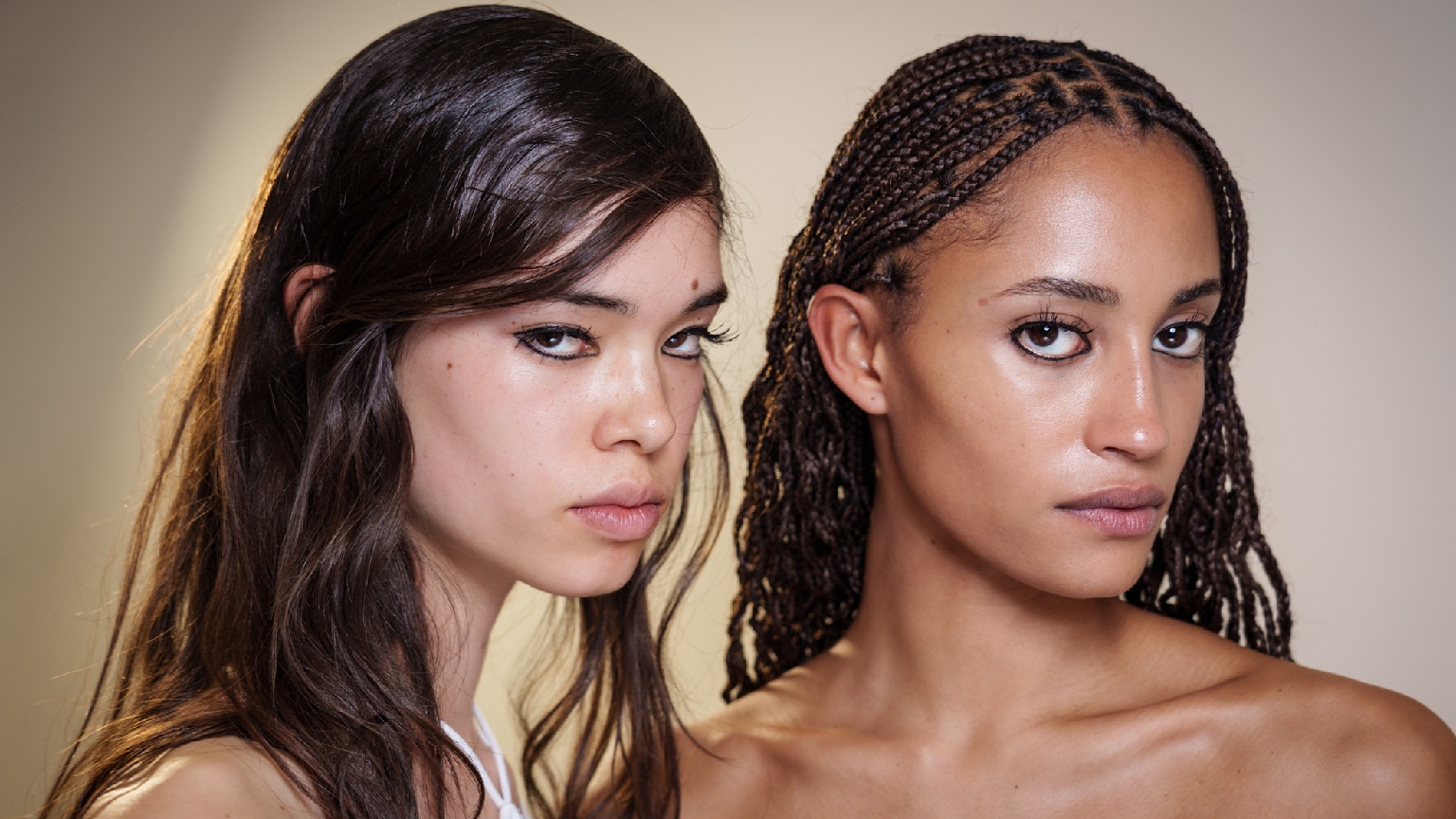 two young women with glowing skin and dark hair