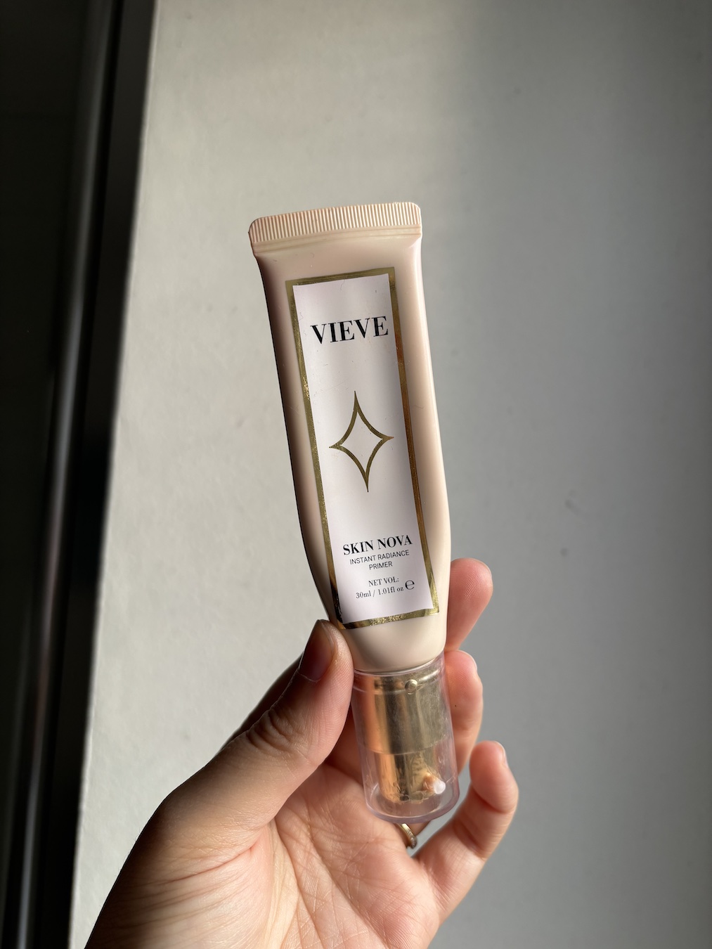 Mica Ricketts holding Vieve Skin Nova Instant Radiance Primer