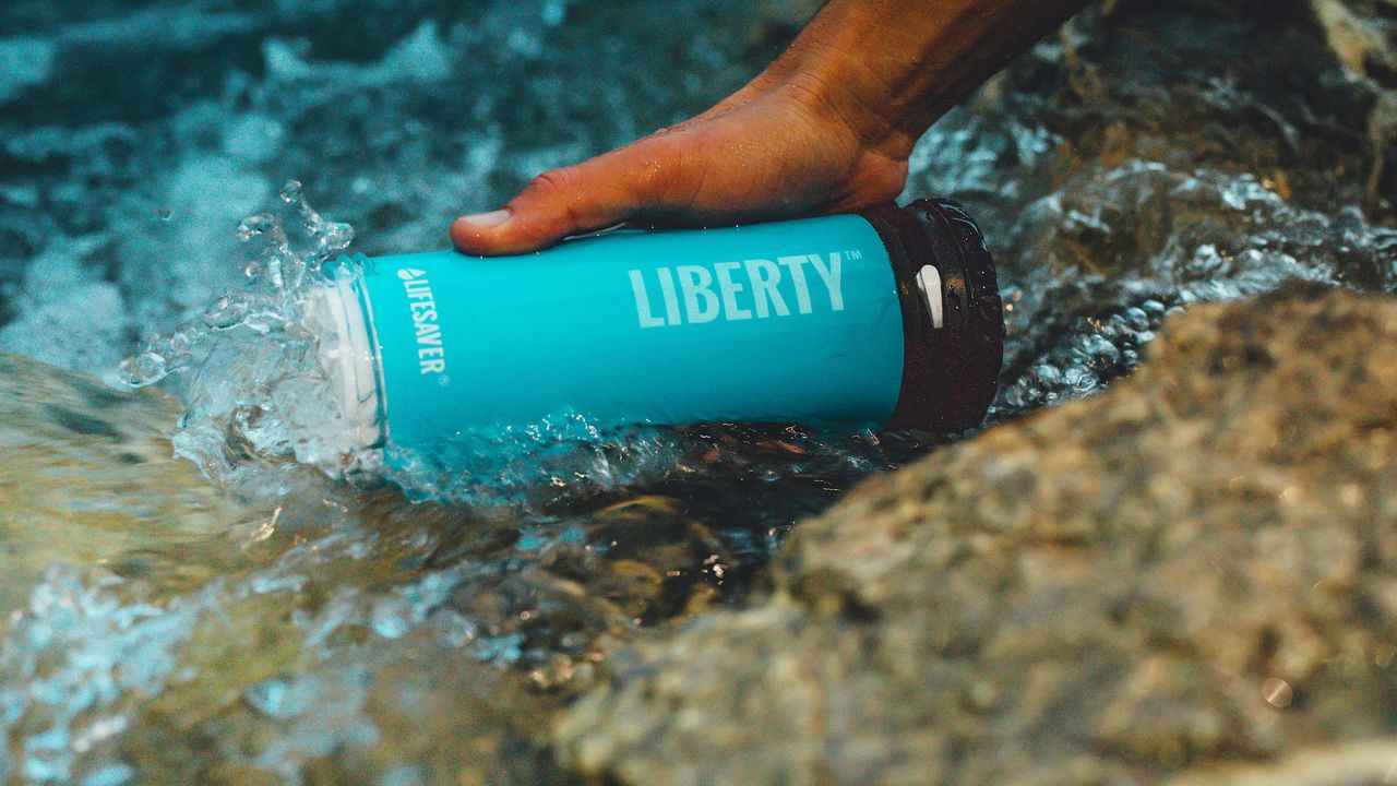 LifeSaver Liberty Water Purifier Bottle review: Pictured here, a person filling up the bottle from a stream