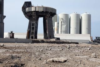 Starship's launchpad stands surrounded by concrete rubble following the rocket's launch.