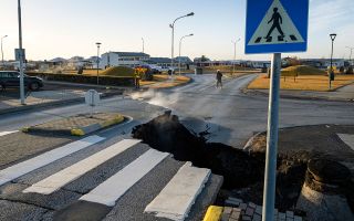 This photo taken on November 13, 2023 shows a crack cutting across the main road in Grindavik, southwestern Iceland following earthquakes