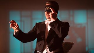 Bradley Cooper blindfolded in the middle of his mentalist act in Nightmare Alley.