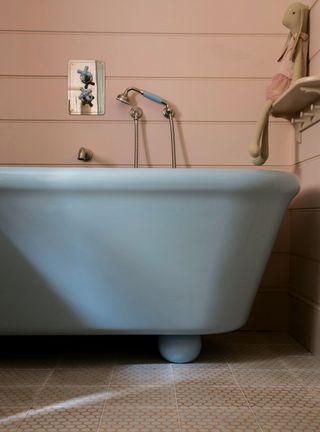 Blue bathroom with beige walls and blue tub