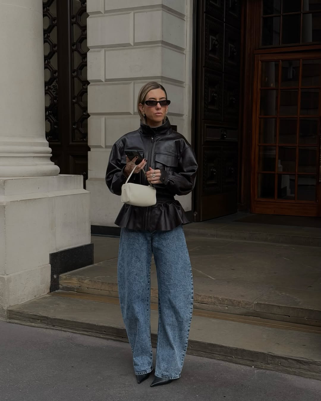 Hannah in leather jacket and jeans