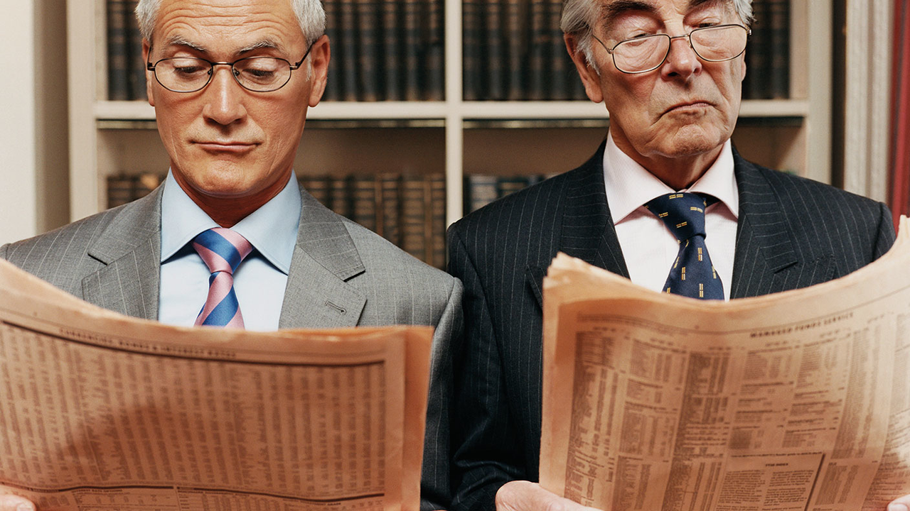 Two men reading the FT