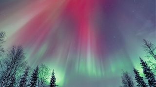 Streaked night sky with northern lights in multiple colours