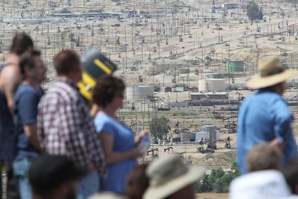 Fans await the race above Bakersfield, California's otherworldly oil pump landscape.