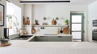 window film applied to kitchen door in white minimalist kitchen