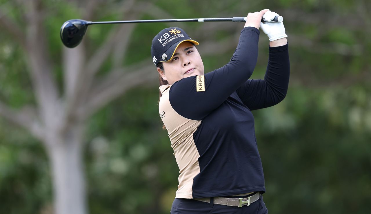 Inbee Park hits her tee shot and watches her flight