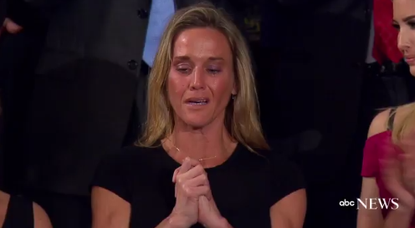 The widow of Navy Seal William "Ryan" Owens listens to applause for her late husband.