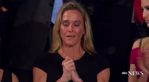 The widow of Navy Seal William &amp;quot;Ryan&amp;quot; Owens listens to applause for her late husband.