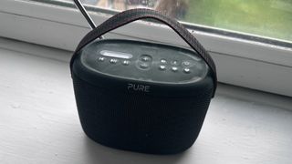 The Pure Woodland Bluetooth speaker and DAB radio sat on a window sill