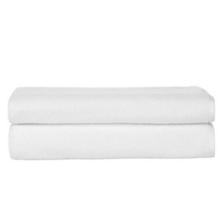 Two folded white rice-weave textured bath towels on top of each other