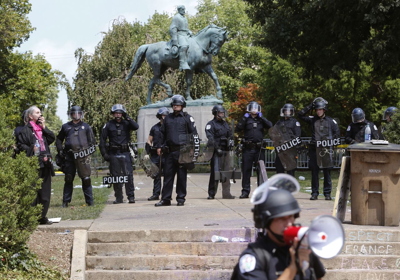 Virginia State Police in riot gear guard Lee Park after a white nationalist demonstration was declared illegal in Charlottesville.