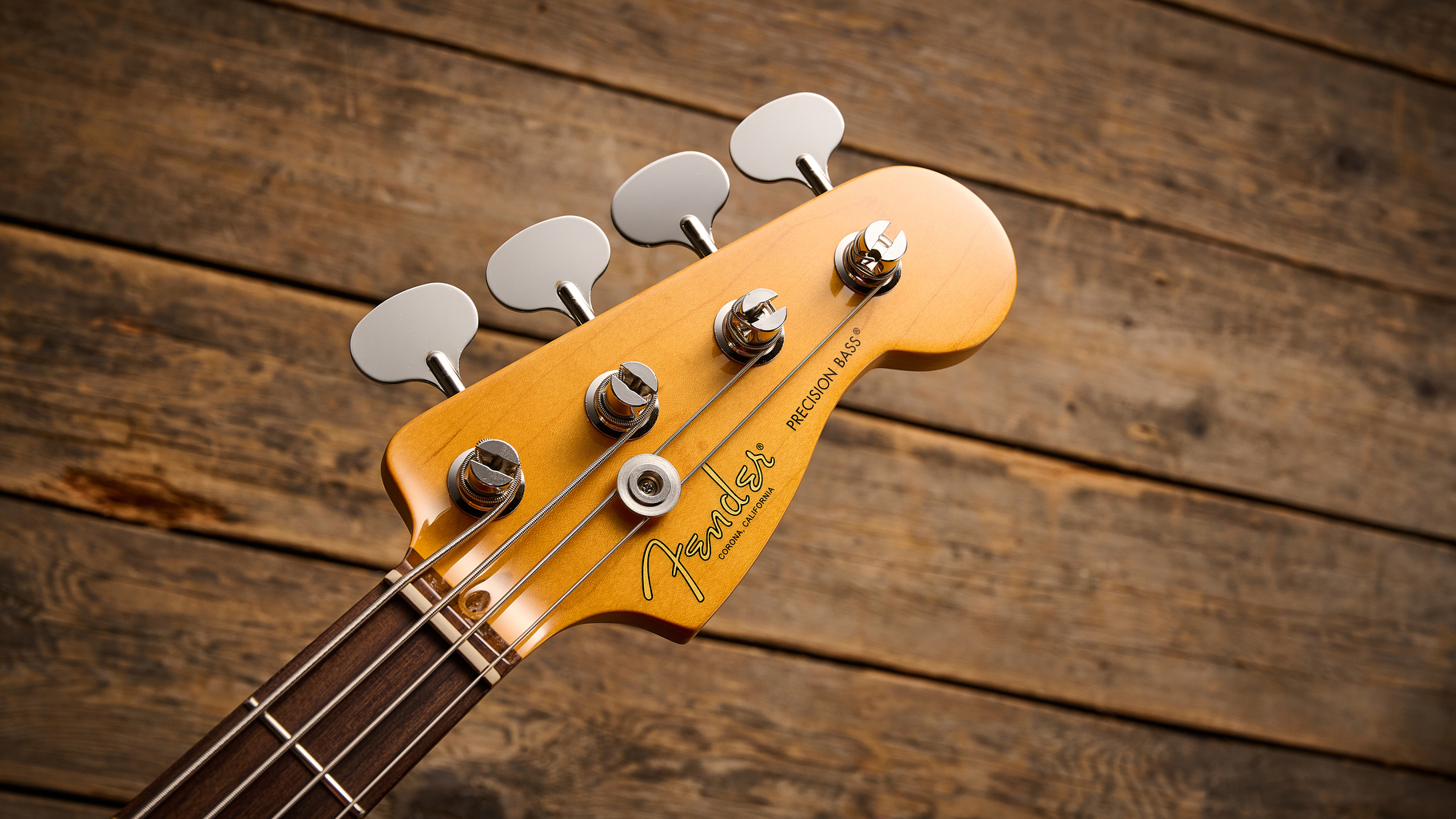 Fender American Professional Classic Precision Bass in 3-Color Sunburst shot on wood floor boards