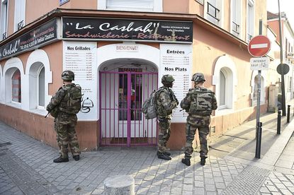 French troops help guard the Parisian suburb of Saint-Denis during an anti-terrorism raid