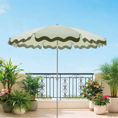 Belavi garden umbrell in green on a sunny balcony with potted plants