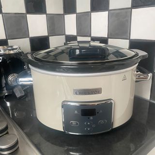A white CrockPot slow cooker on kitchen side