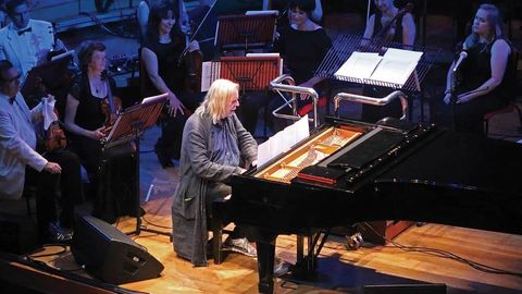 Rick Wakeman plays piano on stage at the Birmingham Symphony Hall
