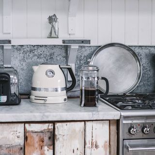 Kitchen with a zinc splashback and rustic wood panelled doors