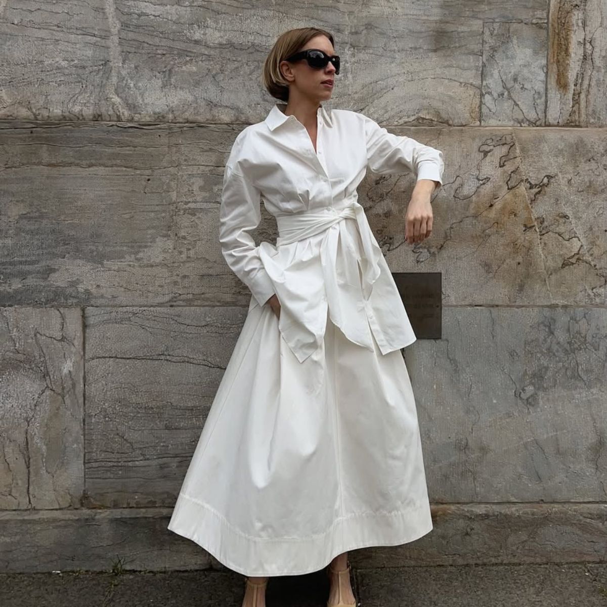 Woman wears white shirt, white skirt and yellow heels