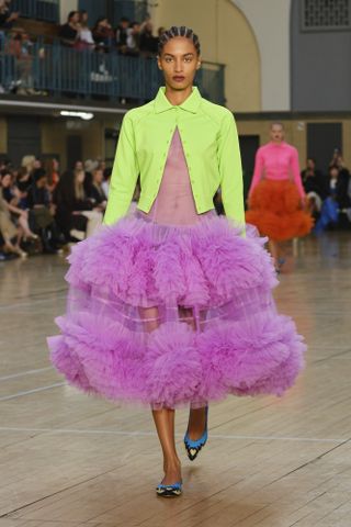 Model on runway wears green top and pink skirt by Molly Goddard at London Fashion Week S/S 2023