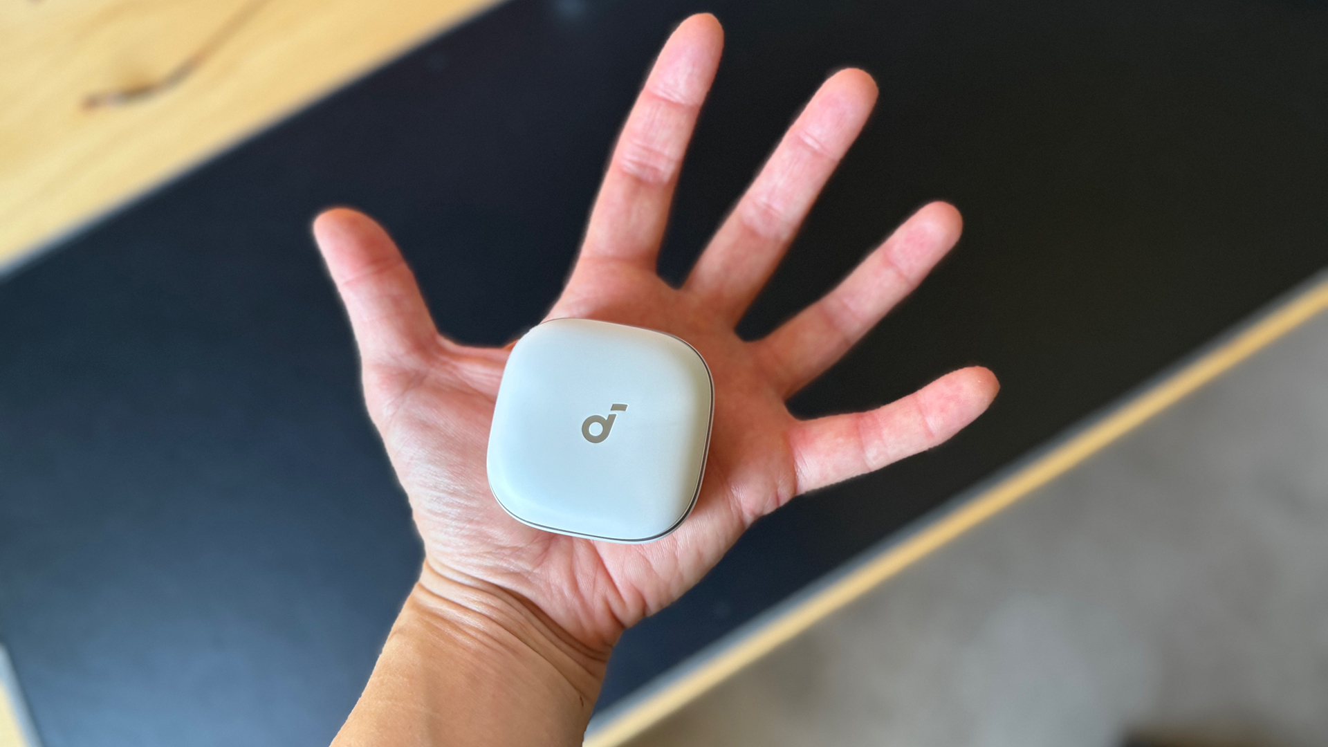 The Soundcore Liberty 5s in the palm of my hand. 