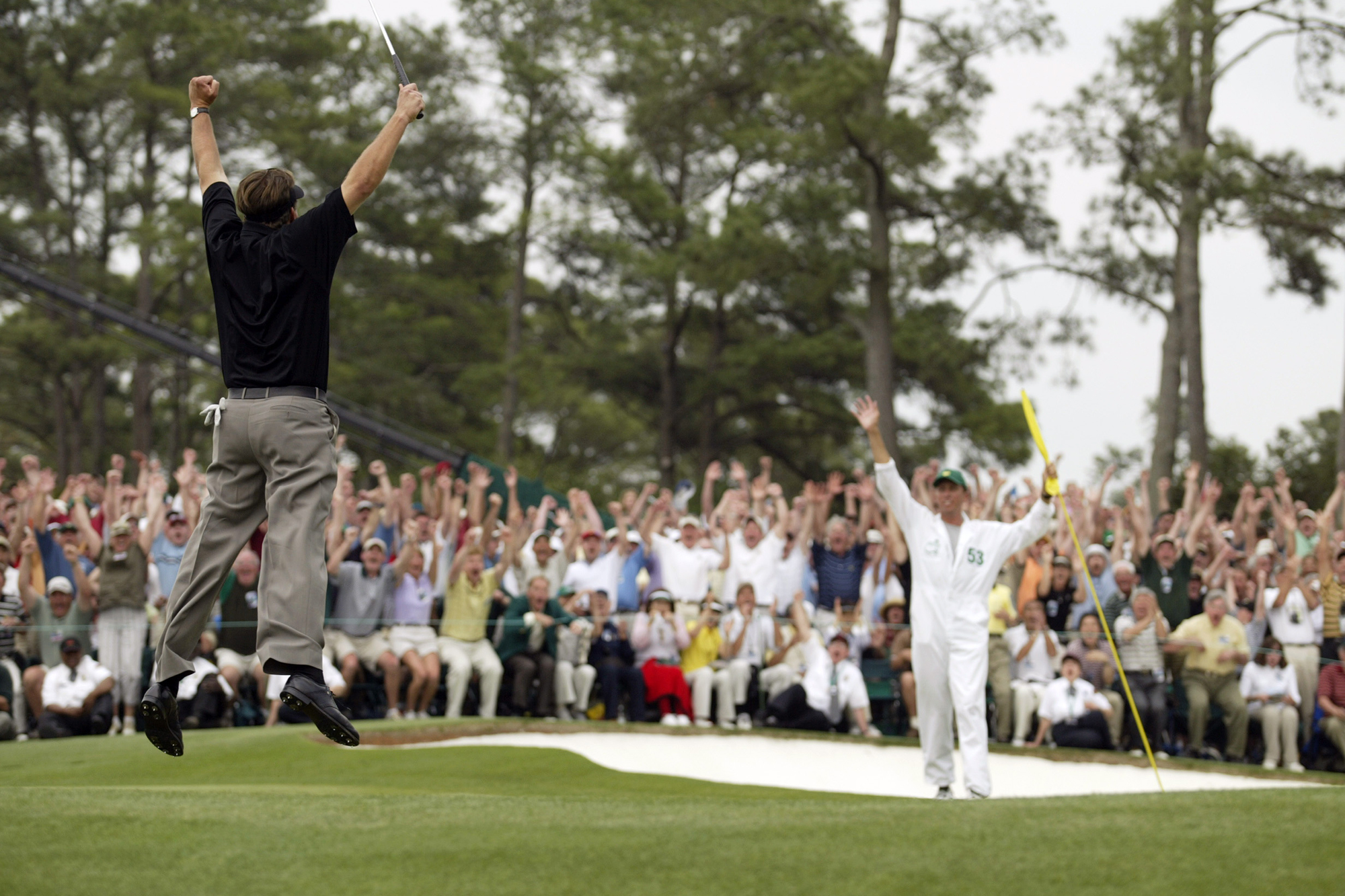 Phil Mickelson leaping in the air in celebration after winning The Masters in 2004
