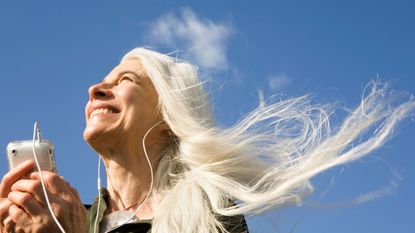 Happy women with long white hair blowing in the wind