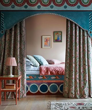 Tiny bedroom with canopy, patterned curtains and colorful bedding
