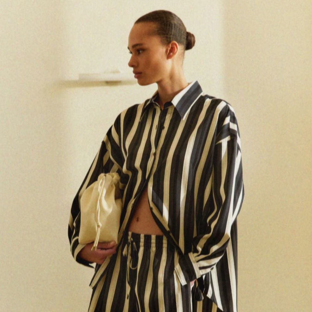 Woman wears striped shirt, paperbag shorts and chunky bangles