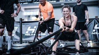 Woman doing sled pull at HYROX event