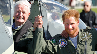 Prince Harry holds hands with 95 year old Battle of Britain Veteran Tom Neil after he landed back at Goodwood Aerodrome in his Spitfire aircraft following a Battle of Britain Flypast on September 15, 2015 in Chichester, England