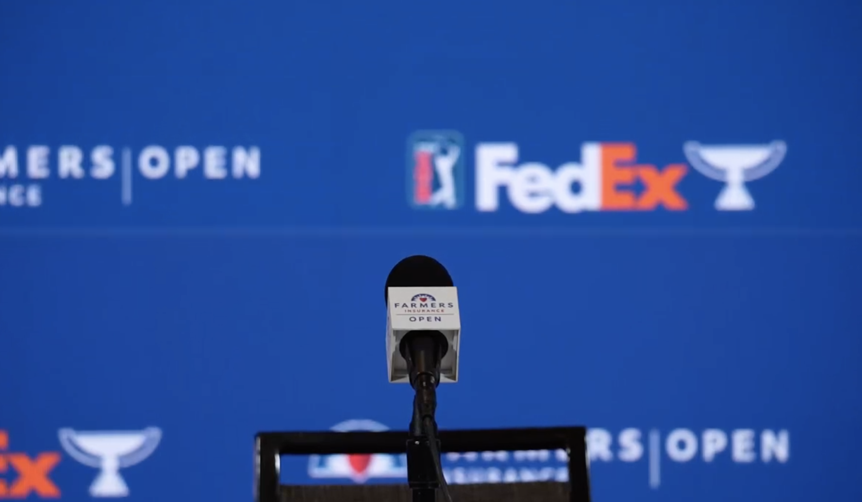The backdrop for the Farmers Insurance Open press conference