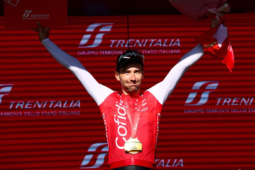 Team Cofidis' French rider Benjamin Thomas celebrates on the podium after winning the 5th stage of the 107th Giro d'Italia cycling race, 178 km between Genova and Lucca, on May 8, 2024 in Lucca. Thomas won ahead of Team EF Education's Danish rider Michael Valgren, second, and Team Polti-Kometa's Italian rider Andrea Pietrobon, third. (Photo by Luca Bettini / AFP)