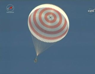 A Soyuz space capsule hangs beneath its parachute while returning Expedition 50 crewmembers Shane Kimbrough of NASA and Russian cosmonauts Sergey Ryzhikov and Andrey Borisenko to Earth in Kazakhstan on April 10, 2017. The landing ended a 173-day mission for the crew.