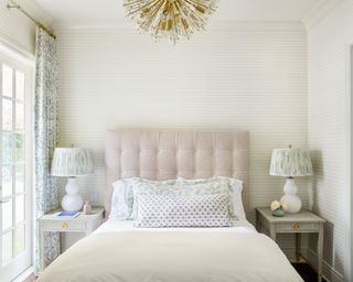 calming bedroom with white color scheme, pale pink headboard