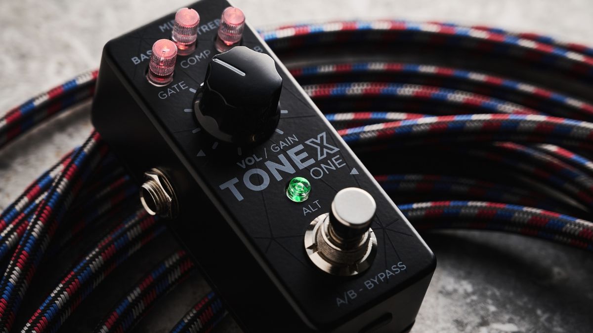 An IK Multimedia Tonex One mini amp modeling pedal lying on a guitar cable