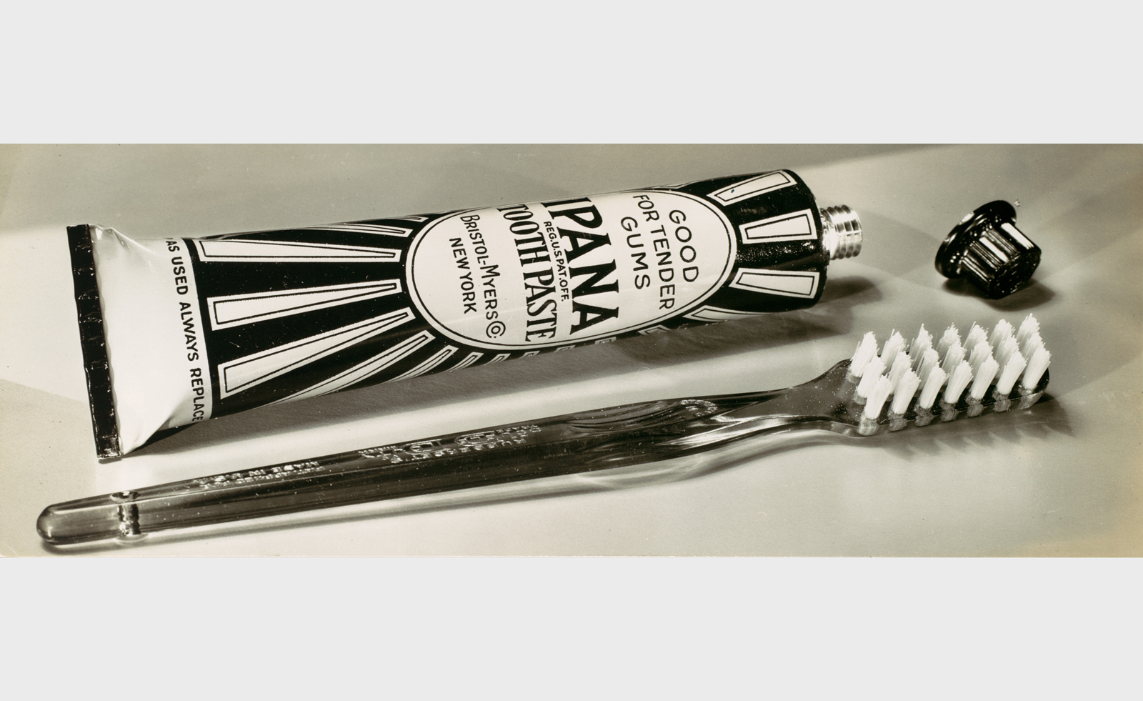 black and white archival photograph of toothpaste and toothbrush