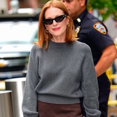 Julianne Moore in New York City wearing a crewneck sweater with a brown skirt and Bottega bag