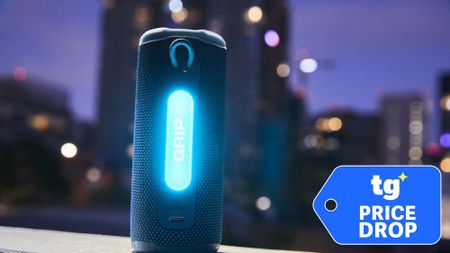 A glowing JBL Grip shown against a city background