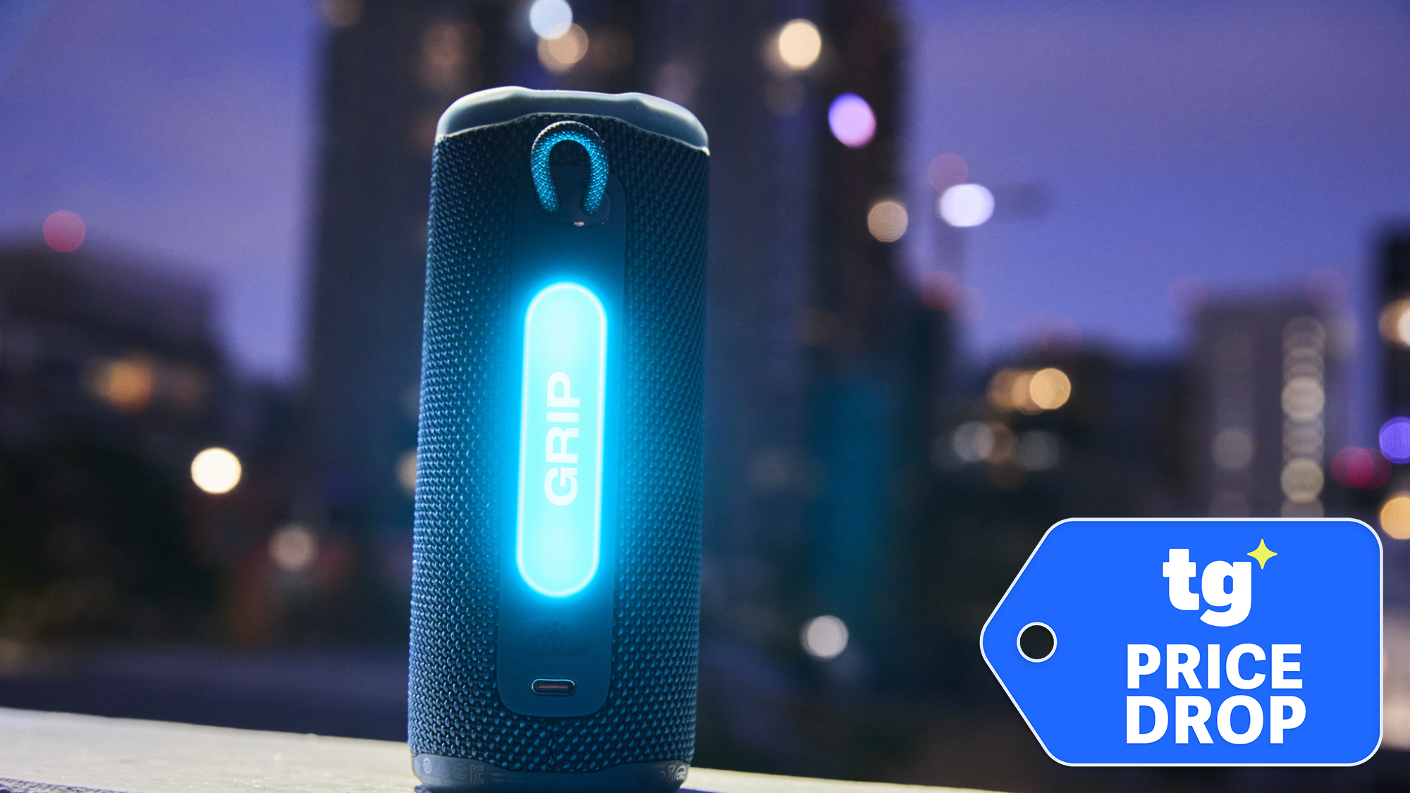 A glowing JBL Grip shown against a city background