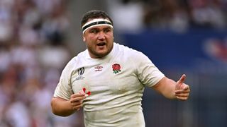 England rugby captain Jamie George, wearing a muddy shirt and holding his mouthguard, ahead of the Italy vs England showdown at the Six Nations Championship 2024 Round 1