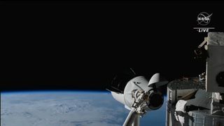 a spacex crew dragon capsule maneuvers to relocate at the international space station