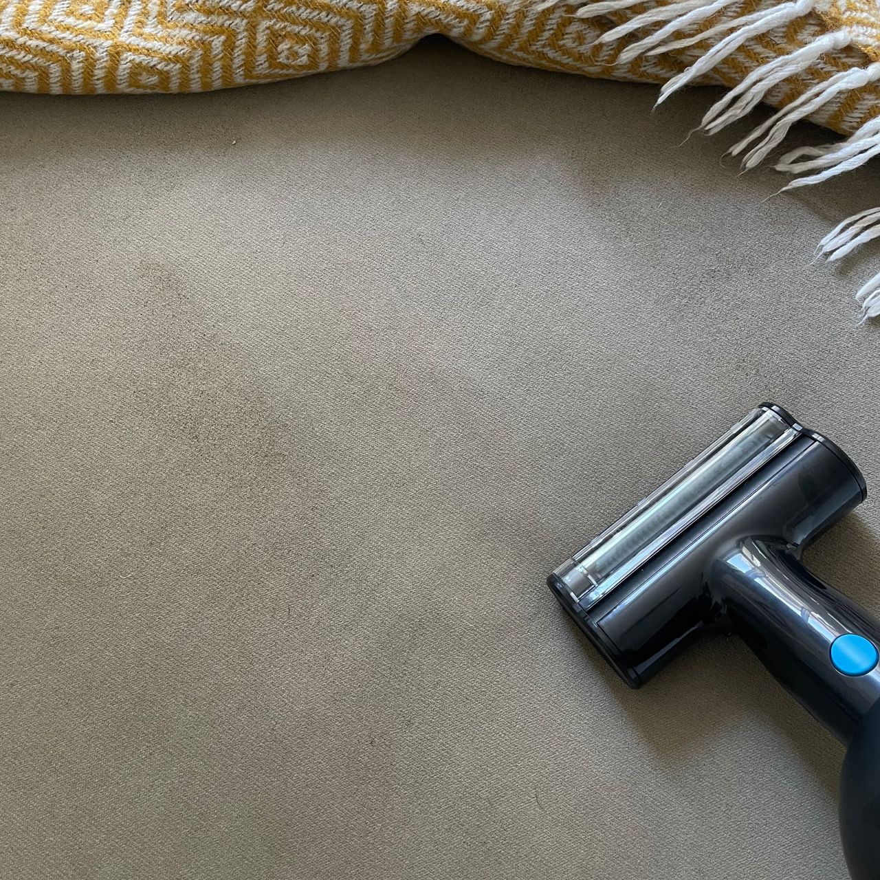 Using mini power brush on a beige footstool