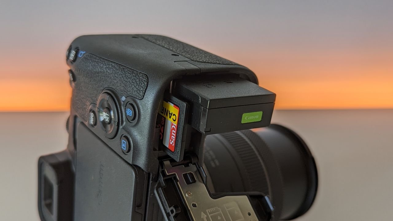 Canon EOS R8 set against a white backdrop with orange glow