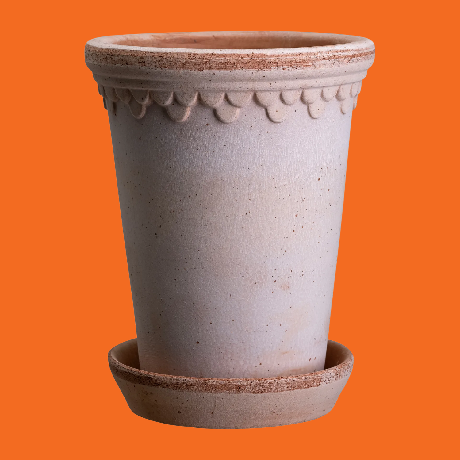 A tall ceramic plant pot with a saucer